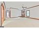Open living room with wood trim, large windows, and a glass-paneled front door at 936 Bo Bo Banks Rd, Grantville, GA 30220