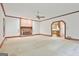 Bright living room with a brick fireplace, wood trim, and neutral carpet at 936 Bo Bo Banks Rd, Grantville, GA 30220