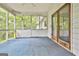 Screened-in porch/sunroom with white trim, blue carpet, and screen windows at 936 Bo Bo Banks Rd, Grantville, GA 30220