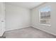 Bedroom features neutral walls, plush carpet, a window with natural light, and closet space at 1528 Wembley Dr, Douglasville, GA 30134