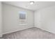 A bright bedroom offers natural light, neutral paint, and plush gray carpeting at 1528 Wembley Dr, Douglasville, GA 30134
