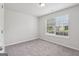 Spacious bedroom with soft carpet, neutral paint, and a window for natural light at 1528 Wembley Dr, Douglasville, GA 30134