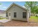 Exterior view of the home with vinyl siding, a concrete patio, and a backyard at 1528 Wembley Dr, Douglasville, GA 30134