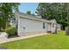 The backyard of the single Gathering home has green grass and a well-maintained exterior at 1528 Wembley Dr, Douglasville, GA 30134
