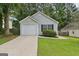Charming single Gathering home with a well-maintained lawn and attached garage at 1528 Wembley Dr, Douglasville, GA 30134