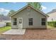 Exterior view of the home with vinyl siding, a concrete patio, and a backyard at 1528 Wembley Dr, Douglasville, GA 30134