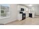 Bright kitchen with black appliances and white cabinets offers functional cooking space at 1528 Wembley Dr, Douglasville, GA 30134