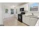 Bright kitchen with black appliances, white cabinets, and a door to the outside at 1528 Wembley Dr, Douglasville, GA 30134