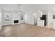Bright and open-concept living room featuring a fireplace and wood-look flooring at 1528 Wembley Dr, Douglasville, GA 30134