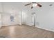Spacious open-concept living room with high ceilings, wood-look flooring and modern ceiling fan at 1528 Wembley Dr, Douglasville, GA 30134