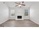Spacious living room featuring modern flooring, a central fireplace and bright windows at 1528 Wembley Dr, Douglasville, GA 30134