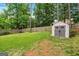 Backyard with a shed and lush green grass, offering a practical storage solution and an expansive lawn for outdoor activities at 2864 Wyndcliff Ct, Marietta, GA 30066