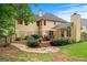 Backyard view of the two-story home with a patio, stone path, and lush landscaping for a peaceful outdoor setting at 2864 Wyndcliff Ct, Marietta, GA 30066