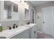 Bright bathroom featuring double sinks with modern fixtures, white cabinetry, and decorative mirrors at 2864 Wyndcliff Ct, Marietta, GA 30066