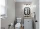 Well-lit bathroom featuring a vanity with granite countertop, modern fixtures, and a decorative mirror at 2864 Wyndcliff Ct, Marietta, GA 30066