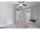 Neutral bedroom with a futon, carpet flooring, ceiling fan, and ample closet space at 2864 Wyndcliff Ct, Marietta, GA 30066