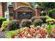 Beautifully landscaped community entrance with a brick sign and colorful flower beds at 2864 Wyndcliff Ct, Marietta, GA 30066