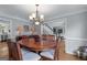 Open dining space featuring hardwood floors, elegant lighting, and adjacent living areas at 2864 Wyndcliff Ct, Marietta, GA 30066