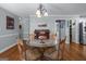 Formal dining room with chandelier, glass table, and seating for four at 2864 Wyndcliff Ct, Marietta, GA 30066