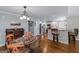 Dining room with a kitchen view, glass table and seating, plus a wooden wine storage cabinet at 2864 Wyndcliff Ct, Marietta, GA 30066