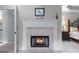 Lit fireplace with mantel and tile surround, and framed artwork above it at 2864 Wyndcliff Ct, Marietta, GA 30066