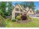 Traditional home with manicured landscaping, a brick retaining wall, and a charming front yard at 2864 Wyndcliff Ct, Marietta, GA 30066