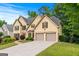 Spacious home with a two-car garage, a large driveway, and lush landscaping for added curb appeal at 2864 Wyndcliff Ct, Marietta, GA 30066