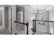 Open hallway featuring decorative molding, a modern chandelier, and dark wood banister at 2864 Wyndcliff Ct, Marietta, GA 30066