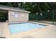 Community pool with clear water, pool house, and nearby basketball hoops in a fenced recreational area at 2864 Wyndcliff Ct, Marietta, GA 30066