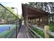 Covered wooden gazebo with seating adjacent to a community tennis court, offering shade and a resting spot at 2864 Wyndcliff Ct, Marietta, GA 30066