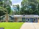 Beautiful exterior showcasing solar panels, a stone accent wall, and a lush, green lawn at 2913 Jordan Forest Trail, Lawrenceville, GA 30044