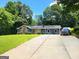Well-manicured front yard with stone details, solar panels, and long driveway at 2913 Jordan Forest Trail, Lawrenceville, GA 30044
