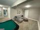 Basement with a pool table, seating area, and neutral walls at 4064 Chimney Ridge Way, Ellenwood, GA 30294