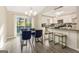 Cozy dining area leading to a modern kitchen with white cabinetry and stainless steel appliances at 4064 Chimney Ridge Way, Ellenwood, GA 30294