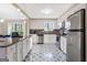 Updated kitchen featuring stainless steel appliances, white cabinets, and decorative tile flooring at 4064 Chimney Ridge Way, Ellenwood, GA 30294