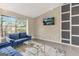 Comfortable living room with a view and plush blue sofas, complemented by contemporary decor at 4064 Chimney Ridge Way, Ellenwood, GA 30294