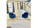 Stylish living room area with velvet chairs and a modern staircase at 4064 Chimney Ridge Way, Ellenwood, GA 30294