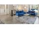 Modern living room with two plush blue sofas, gray wood floors, and a stylish glass coffee table at 4064 Chimney Ridge Way, Ellenwood, GA 30294