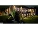Nighttime view of a home exterior with extensive lighting and covered deck at 4564 Investors Ln, Ellenwood, GA 30294