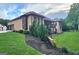Grassy backyard with landscaping and a multi-level deck at 4564 Investors Ln, Ellenwood, GA 30294