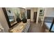 Well-lit bathroom featuring a double vanity with granite countertops and tile flooring at 4564 Investors Ln, Ellenwood, GA 30294