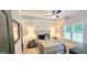This bedroom boasts neutral tones, with dark accents and ceiling fan at 4564 Investors Ln, Ellenwood, GA 30294