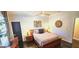 Stylish bedroom featuring dark wood floors, a ceiling fan, and a zebra painting on the wall at 4564 Investors Ln, Ellenwood, GA 30294