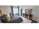 Stylish bedroom featuring a modern platform bed, dresser with mirror, and view to a bright window at 4564 Investors Ln, Ellenwood, GA 30294