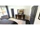 Well-appointed bedroom with a sophisticated dresser, a window, and modern doors at 4564 Investors Ln, Ellenwood, GA 30294
