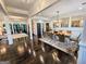 Elegant dining room with dark hardwood floors, designer rug, and modern chandelier at 4564 Investors Ln, Ellenwood, GA 30294