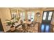 Bright dining room featuring dark hardwood floors, wainscotting, and elegant light fixtures at 4564 Investors Ln, Ellenwood, GA 30294