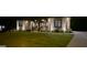 Well-lit brick home exterior featuring manicured lawn and decorative shrubs at 4564 Investors Ln, Ellenwood, GA 30294