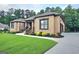 Charming brick home featuring a well-manicured lawn and professional landscaping at 4564 Investors Ln, Ellenwood, GA 30294