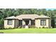 Charming brick house featuring a manicured lawn and mature landscaping at 4564 Investors Ln, Ellenwood, GA 30294